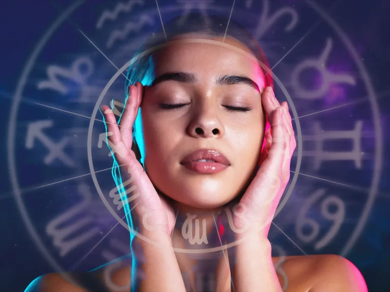 A woman holding her head with zodiac signs coming out.