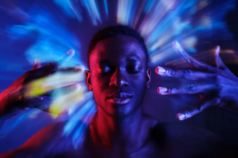 A man meditating a light comes out of his head